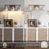 image:imageNathan James Aubrey 3Lights Farmhouse Wall Light Fixture Bathroom Vanity Light with Brass Metal Frame and Gold and White Cage Shades for Bathroom and Vanity Gold BrassWhiteGold BrassWhite