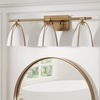image:imageNathan James Aubrey 3Lights Farmhouse Wall Light Fixture Bathroom Vanity Light with Brass Metal Frame and Gold and White Cage Shades for Bathroom and Vanity Gold BrassWhiteGold BrassWhite